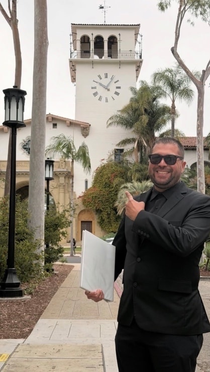 Mike pointing at a clock — always on time for your ceremony
