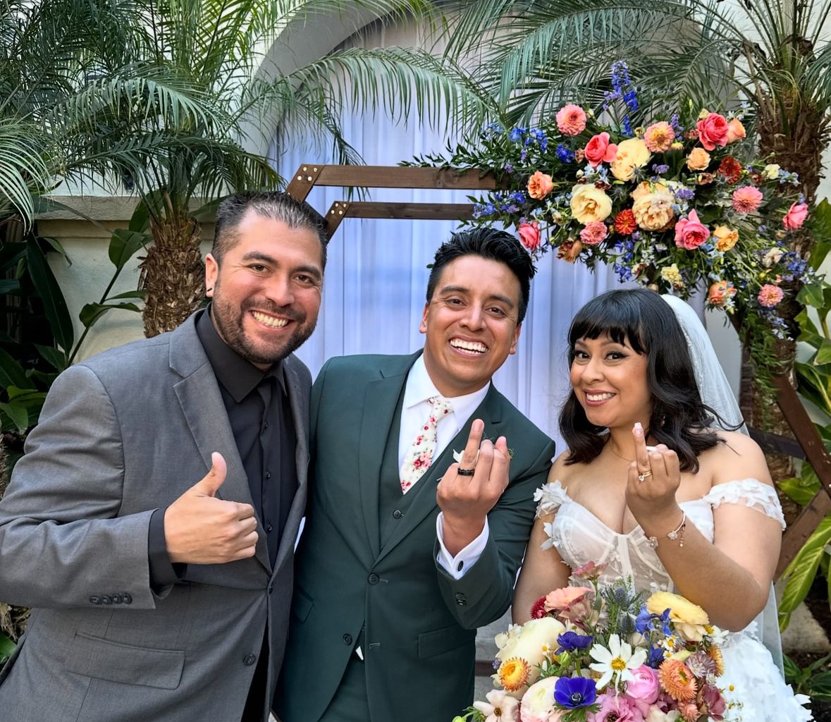 Mike officiating as a bride lifts her veil