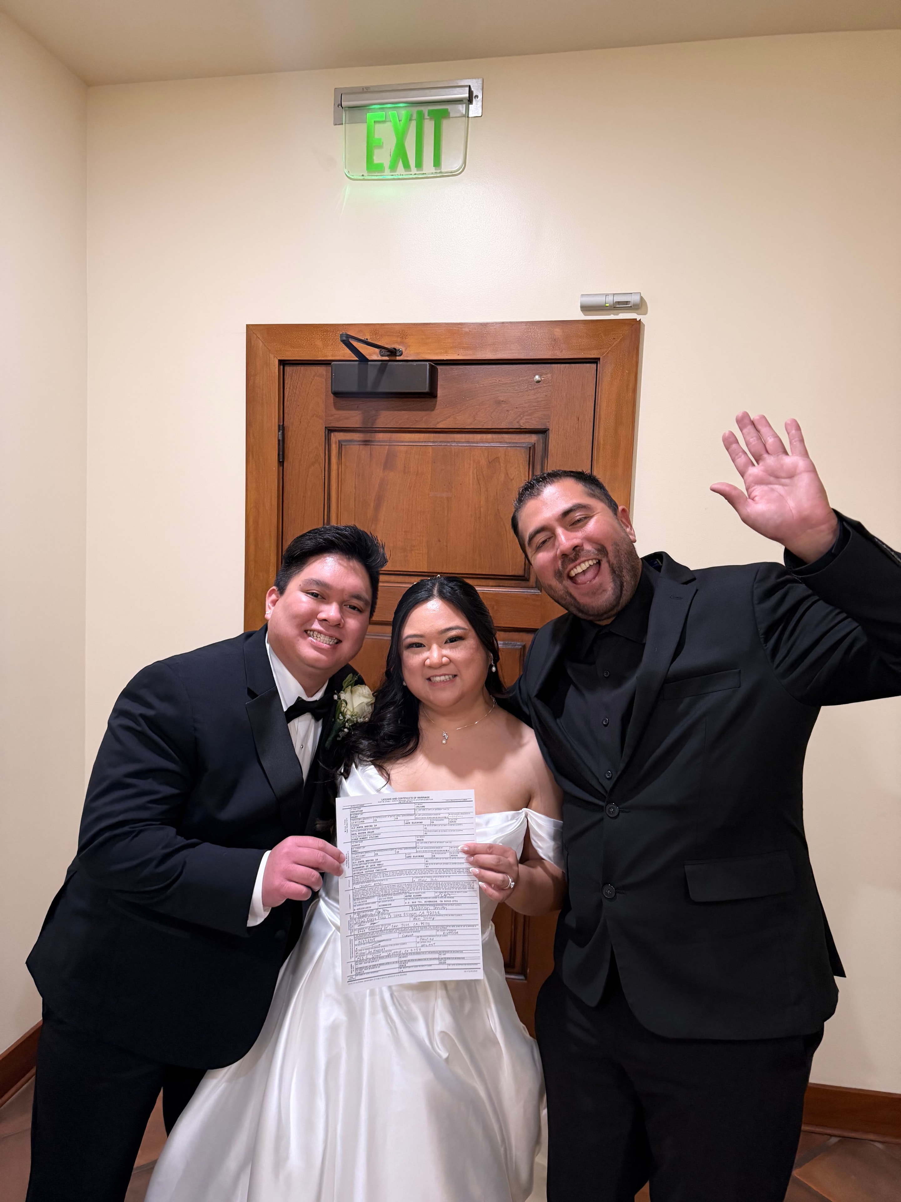 Mike celebrating with newlyweds holding their marriage license at the courthouse
