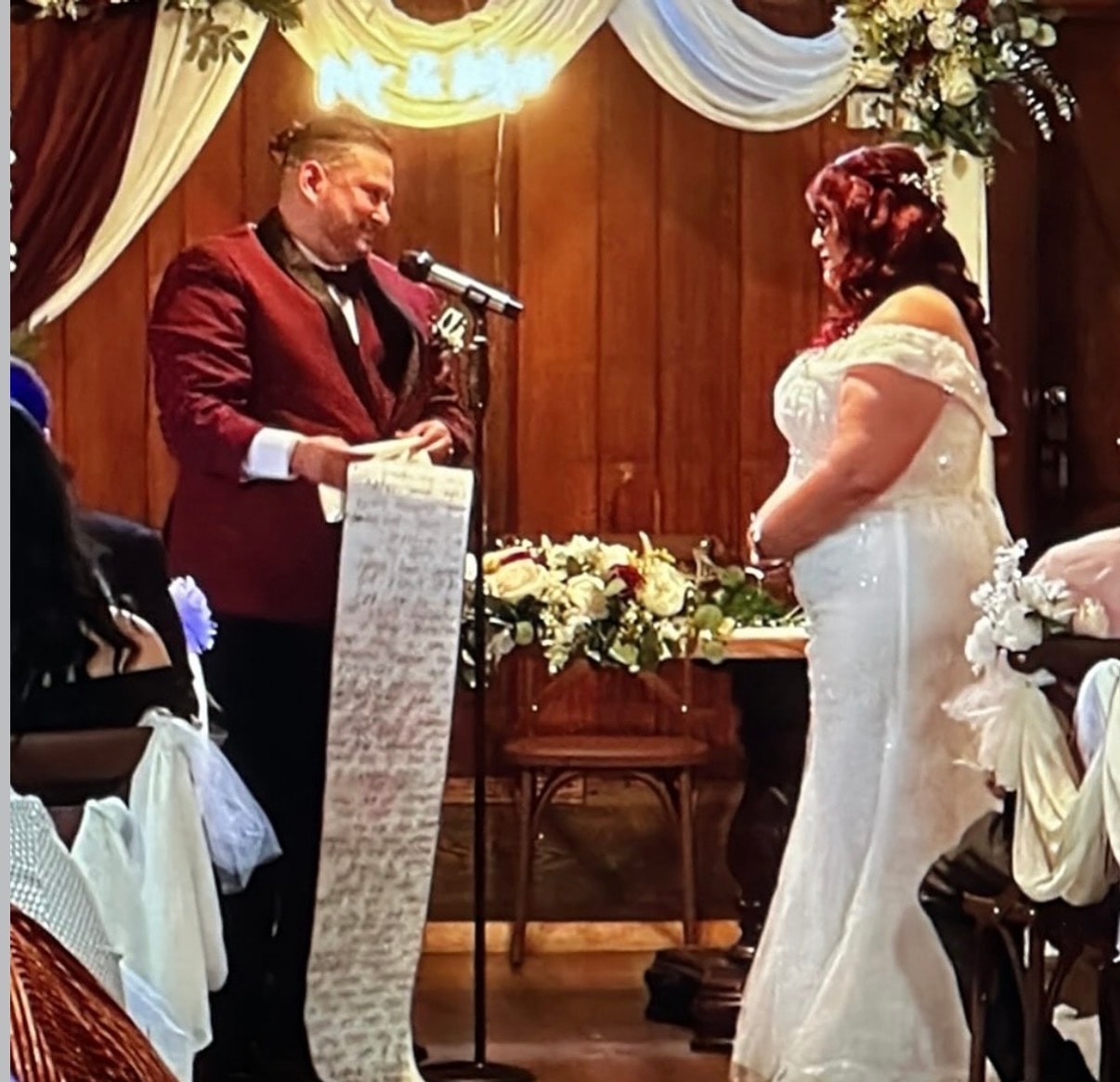 Groom reading heartfelt vows to bride during ceremony